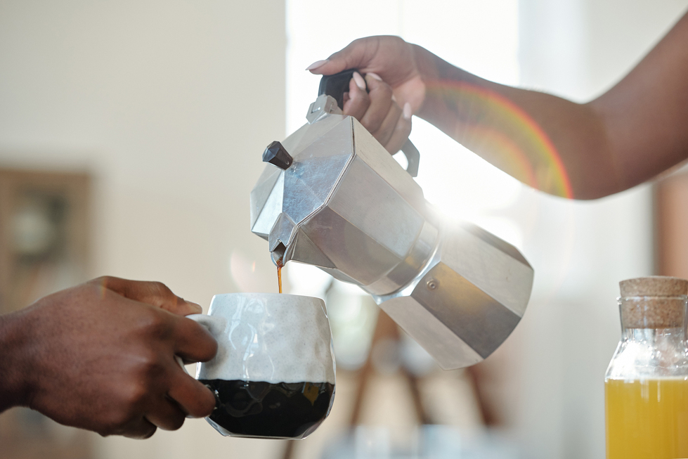 Image of a someone pouring coffee into someone elses mug